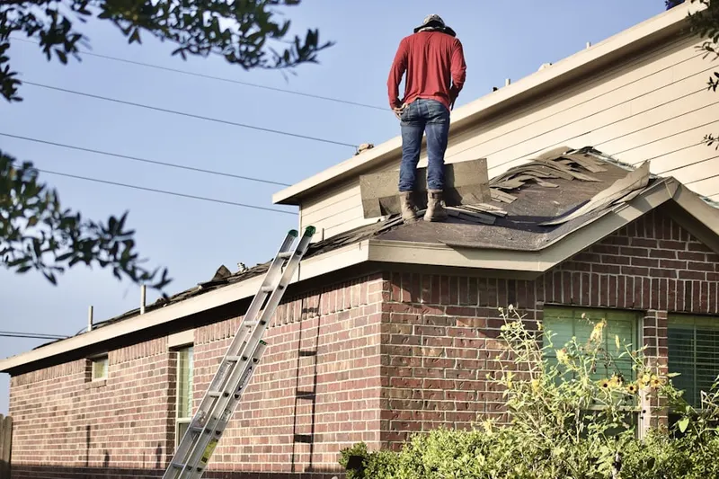 Professional roofer working on a residential roof in Calais Crossroads